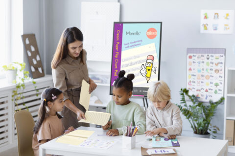 RMHFC young woman doing handwriting with children - Rhino Stationery